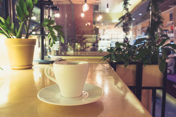 closeup image of coffee cup at cafe table. Cafe interior