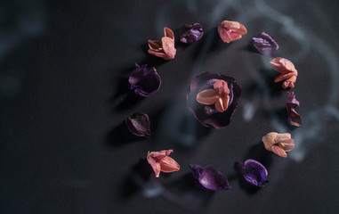The culture of zen and meditation. A circle of dry flowers on a dark background. A copyspace for...