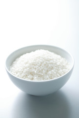 Fototapeta na wymiar A Bowl Of The Raw White Rice On White Background