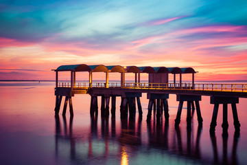 A beautiful ocean dramatic sunset and fishing pier at Jekyll Island in coastal Georgia, USA. - obrazy, fototapety, plakaty
