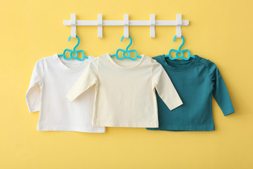 Baby clothes on a hanger. Place for text, minimalism.