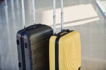 Black and white suitcases in airport hall at daytime