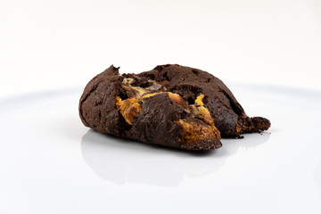 A cookie cake with chocolate on white background with copy space - angled view