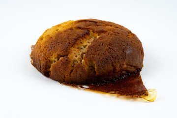 A cookie cake with peanut butter and caramel on white background with copy space - angled view