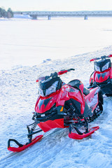 Red snowmobiles in frozen lake at winter Rovaniemi