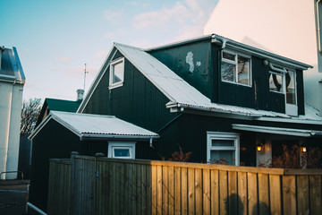 Beautiful green wooden icelandic house in Reykjavik at sunset