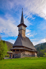 Fototapeta na wymiar Traditional Maramures neo gothic wooden church in Barsana monastery, Romania