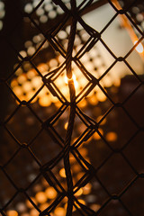 Metal wire in a metal fence in a sunset