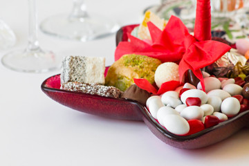 Traditional Turkish Hard Candies ,delight and dessert in red glass plate with stylish ribbon.Conceptual image for celebrations.