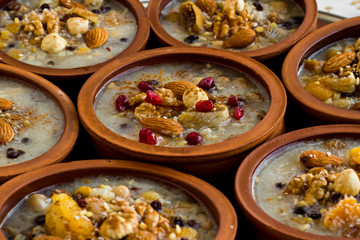 Traditional Turkish Dessert Asure,Ashura or Noah's Pudding in ceramic casserole bowls,selective focus.