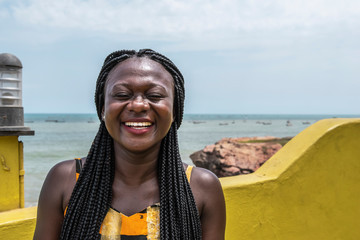 Happy Africa Woman from Ghana stands on the coast in Accra city.
