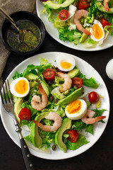 Healthy fresh vegetable salad with shrimps, boiled eggs and avocado