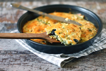 Selective focus. Frying pan with a pie with cabbage and olives. Freshly baked homemade cabbage pie. Healthy food.