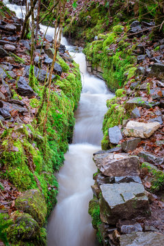 A narrow stepped rocky waterfall on the Elidir Trail; in the Brecon Beacons, Wales. Long exposure
