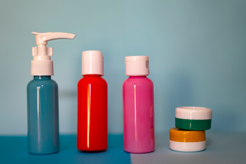 Set of travel bottles in a blue background.