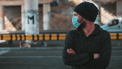 Hipster Man In A Medical Mask For Protection Against Virus Flu Or Coronavirus Outdoor. Corona Virus Pandemic. Epidemic Viral Respiratory Syndrome. 2019-nCoV. High Quality Photo