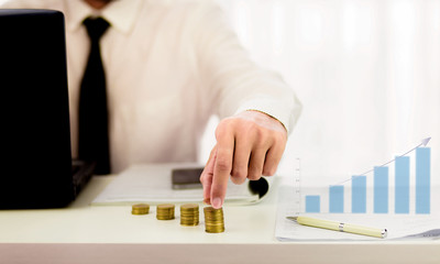 Business investment growth and financial graph with stack of coins on office desk 