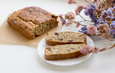 healthy homemade sugar pie on white background with flowers. Pie with raisins and nuts