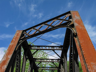 Rusty Railroad Bridge Against an Intense Blue Sky