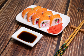 Philadelphia rolls and ginger on the plate. wooden