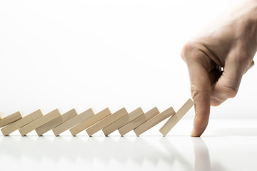 The effect of falling dominoes. The financial crisis and economic decline. Risk concept.
