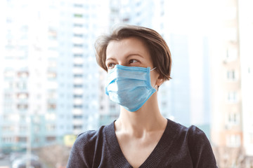 Woman with surgical protective mask on the street.
