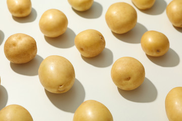 Flat lay with young potato on white background