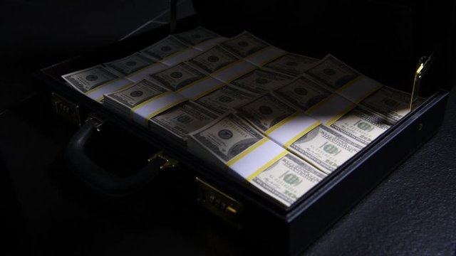 Stacks of 100 dollar bills in a briefcase , briefcase full of money .