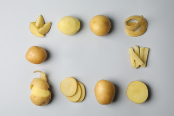Young potato on grey background, top view and space for text