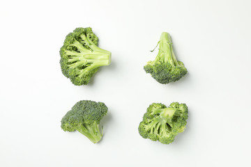Flat lay with broccoli on white background, top view