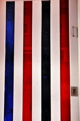 Old and colorful striped wooden door with iron details