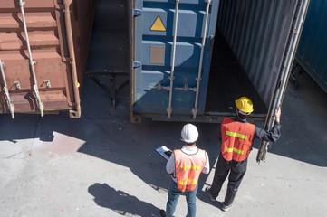 Foreman control loading containers box from cargo freight ship for import export, Foreman control...