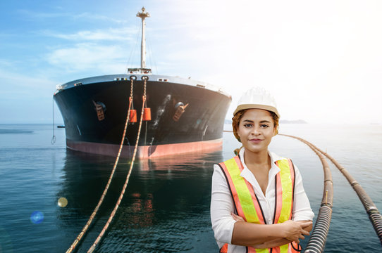 mixed race woman engineer staff worker and oil tanker ship background concept.