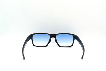 Stylish black glasses with blue tinted lens isolated on white background.