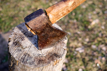 Old rusty ax in log