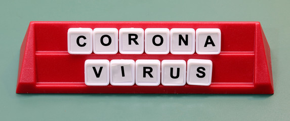 Coronavirus text made with plastic letters on a lectern