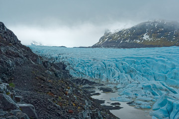 Sólheimajökul blue glacier under a cloudy sky, Iceland