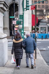 Elderly couple walking in manhattan during corona virus outbreak
