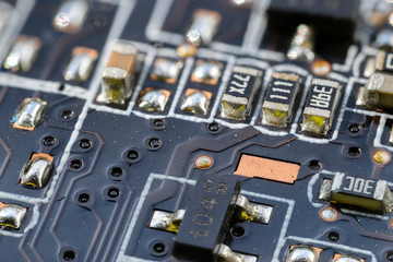 Resistors on computer motherboard in macro view.