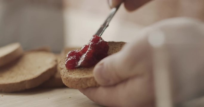 Spreading jam on a rusk