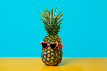 pineapple wearing heart-shaped sunglasses.