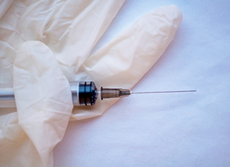layout, on the glove lies a syringe and a blister with tablets. toned in blue