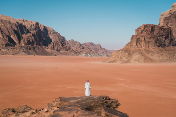 A man standing on  top of the hill in Wadi Rum desert, Jordan, Arab