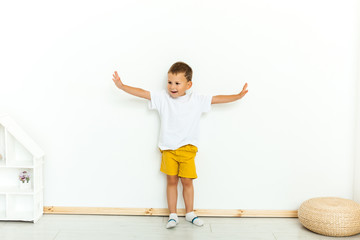Cute little boy in yellow shorts and white t-shirt