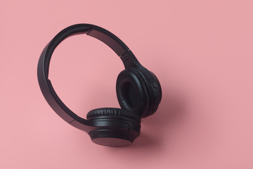 Fototapeta na wymiar Professional wireless headphones isolated on pink background
