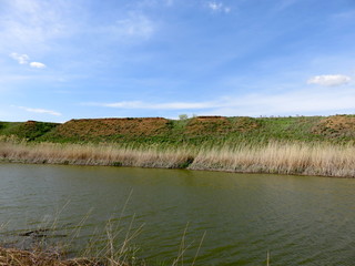 Blue sky with clouds over a river