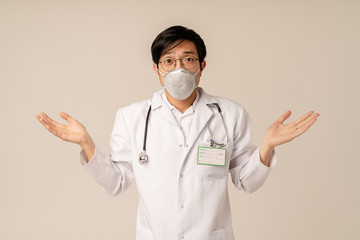 Image of asian doctor in uniform and protective mask throwing up arms