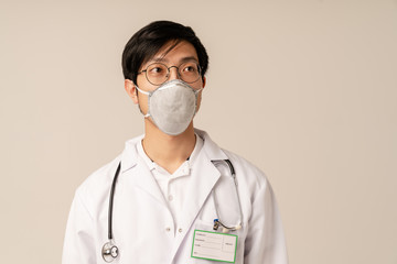 Image of asian young male doctor in medical uniform and protective mask