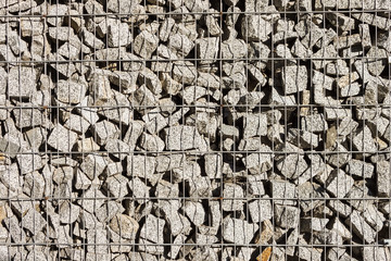 The texture of the gabion fence is made of natural stone and metal mesh