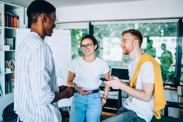 Fototapeta premium Smiling coworkers talking with each other